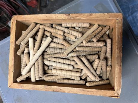 Box of wooden dowels.
