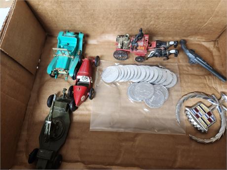 Toy cars and a Cadillac hood ornament