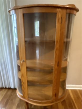 Crescent, oak, and glass curio cabinet
