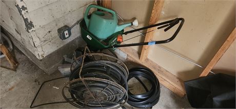 spreader, hose and watering can
