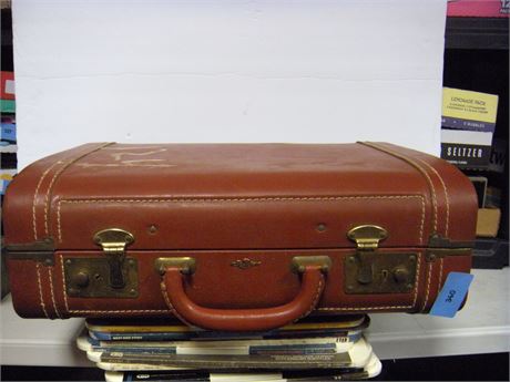 Suitcase and travel books